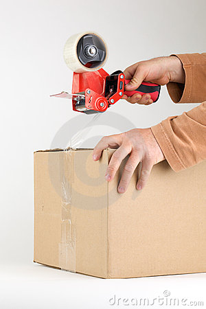 Man using a carton sealing tape closing a box